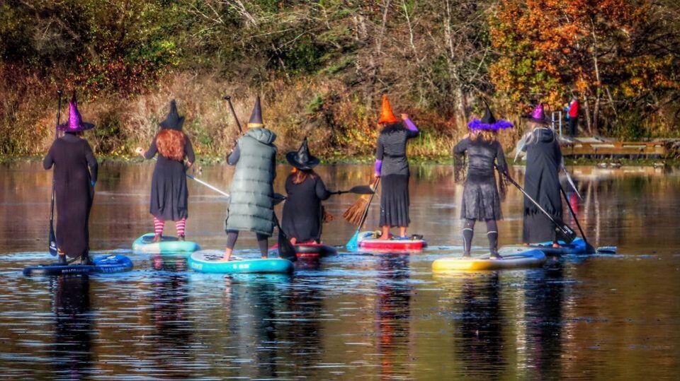 Witches paddle at Lake Clare